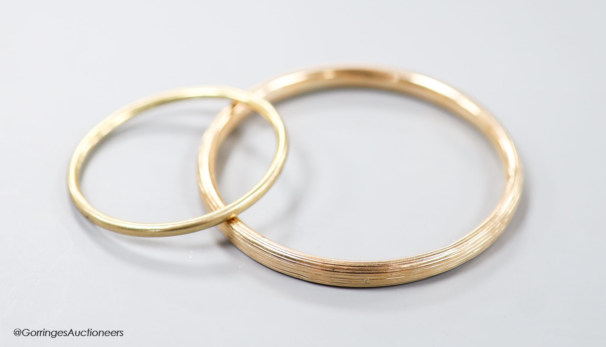 Two yellow metal bangles, the smallest stamped 9ct